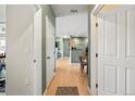 Bright hallway with wood flooring and neutral paint that provides access to the home's various living spaces at 9622 W Coco Cir # 203, Littleton, CO 80128