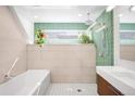 Modern bathroom with a separate shower stall and tub, featuring green accent tiles and unique plant decor at 1718 W 33Rd Ave, Denver, CO 80211