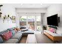 Comfortable living room with sliding glass doors leading to a patio and a mounted television at 1718 W 33Rd Ave, Denver, CO 80211