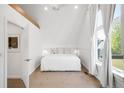 Bright bedroom with hardwood floors, large window with white curtains, and white walls at 1718 W 33Rd Ave, Denver, CO 80211