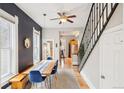 A dining area boasts modern design, accented by dark walls, unique mirror, and stylish blue chairs at 953 Kalamath St, Denver, CO 80204