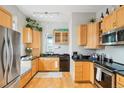 Light and bright kitchen with wood cabinets, modern appliances, and lots of room for cooking at 953 Kalamath St, Denver, CO 80204