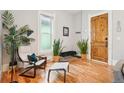 Cozy living room with a decorative wooden door, stylish decor, and natural light at 953 Kalamath St, Denver, CO 80204
