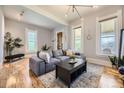Bright living room features a comfortable gray sectional sofa, stylish lighting, and hardwood floors at 953 Kalamath St, Denver, CO 80204