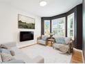 Bright living room with modern fireplace, large windows, and stylish neutral decor at 2120 Pintail Dr, Longmont, CO 80504