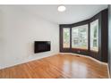 Bright living room with hardwood floors, a modern fireplace, and large windows at 2120 Pintail Dr, Longmont, CO 80504