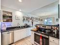 Well-lit kitchen features stainless steel appliances, granite countertops, and tile flooring at 1057 Delta Dr # A, Lafayette, CO 80026