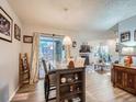 Open-concept living area with hardwood floors, fireplace, and sliding glass doors to patio at 1057 Delta Dr # A, Lafayette, CO 80026