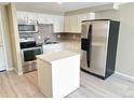 Bright kitchen features stainless steel appliances, white cabinets, and subway tile backsplash at 8828 E Florida # 113, Denver, CO 80247