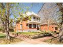 Beautiful brick home with a covered front porch, stone foundation and well-maintained landscaping at 3905 Tejon St, Denver, CO 80211