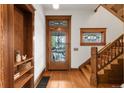 Inviting foyer with hardwood floors, wooden staircase, and stained glass window above the front door at 3905 Tejon St, Denver, CO 80211