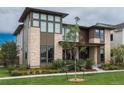 Beautiful two-story home featuring stone accents, a modern design, manicured lawn, and professional landscaping at 5866 Boston Ct, Denver, CO 80238