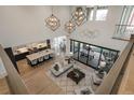 Overhead view of an open concept living room showcasing modern lighting and an adjacent kitchen and dining area at 5866 Boston Ct, Denver, CO 80238