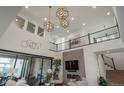 Bright living room with high ceilings, modern lighting fixtures, a fireplace, and large sliding glass doors at 5866 Boston Ct, Denver, CO 80238