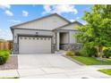Charming single-Gathering home with a two-car garage, stone accents, and a well-kept lawn in a suburban neighborhood at 9628 Albion Ln, Thornton, CO 80229