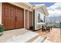 Inviting front porch with double doors and wooden chairs, perfect for relaxing at 14126 W Harvard Pl, Lakewood, CO 80228