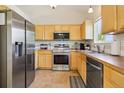 Bright kitchen featuring stainless steel appliances and wood cabinetry at 16304 10Th St, Mead, CO 80542
