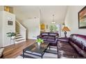 Cozy living room with hardwood floors and comfortable leather sofas at 16304 10Th St, Mead, CO 80542