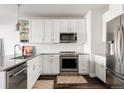 Modern kitchen featuring white cabinetry, stainless steel appliances, and subway tile backsplash at 20 Wilcox St # 403, Castle Rock, CO 80104