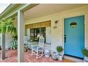 Inviting front porch with white rocking chairs, blue door, and potted plants at 225 N Ivanhoe St, Denver, CO 80220