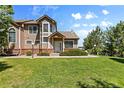 Charming townhome exterior with well-manicured lawn and established landscaping at 6825 S Webster St # A, Littleton, CO 80128