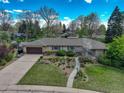 Aerial shot showcases the property's landscaped yard, sprawling layout, and peaceful neighborhood setting at 6544 E Alaska Dr, Denver, CO 80224