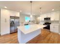 Beautiful kitchen with stainless steel appliances, white cabinets, quartz countertops, and island at 2090 S Clinton St, Denver, CO 80231