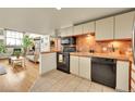 An open kitchen with tile flooring, tiled countertops, and stainless steel appliances at 2351 Federal Blvd # 401, Denver, CO 80211