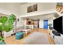 Open-concept living area with bright interior, hardwood floors, and high ceilings at 2351 Federal Blvd # 401, Denver, CO 80211