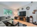 Comfortable living room with a large window, plush seating, and stylish decor at 4849 S Pitkin Way, Aurora, CO 80015
