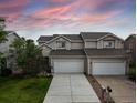 Inviting home exterior featuring a well-maintained lawn and a two-car garage at 849 Canary Ln, Brighton, CO 80601