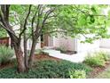 Charming front yard with mature trees, landscaping, and a welcoming entrance at 849 Canary Ln, Brighton, CO 80601