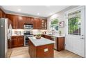 Modern kitchen with wood cabinets, stainless steel appliances, and a white quartz island at 2908 N Florence St, Denver, CO 80238