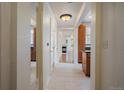 Hallway view showcasing neutral walls and trim, tile floors, and wooden cabinets at 1521 Vine St # 101, Denver, CO 80206
