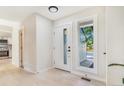 Bright foyer with a modern white door, clean lines, and light wood floors at 3713 S Ensenada St, Aurora, CO 80013