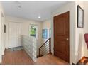 Welcoming entryway with wood floors, glass block accent, and natural light, offering a warm greeting at 1470 S Quebec Way # 245, Denver, CO 80231