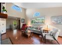 Bright living room featuring high ceilings, large windows, hardwood floors, and comfortable seating at 1470 S Quebec Way # 245, Denver, CO 80231