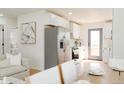 Bright, modern kitchen with stainless steel appliances and white cabinetry at 930 S Lowell Blvd, Denver, CO 80219