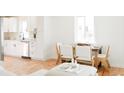 Open living space with kitchen view and a dining table at 930 S Lowell Blvd, Denver, CO 80219