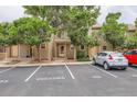 Street view of townhomes with visitor parking and mature trees, providing shade and curb appeal at 11155 W 17Th Ave # 103, Lakewood, CO 80215