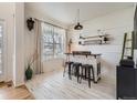 Chic bar space featuring a rustic counter, shelving, pendant lighting, and eye-catching decor at 8367 Devinney St, Arvada, CO 80005