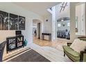 Welcoming entryway with hardwood floors, stylish decor, and open access to other rooms at 8367 Devinney St, Arvada, CO 80005