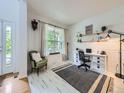 Bright office space with white shiplap walls, large window, and functional desk area at 8367 Devinney St, Arvada, CO 80005