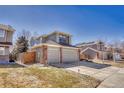 View of home with two-car garage and nice yard at 17798 E Ida Ave, Centennial, CO 80015