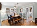 Cozy dining area with a wooden table set, bench, and view into the kitchen at 3242 Utica St, Denver, CO 80212