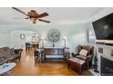 Inviting living room with hardwood floors, vintage ceiling fan, and elegant furniture arrangement at 3242 Utica St, Denver, CO 80212