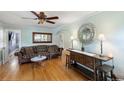 Bright living room featuring hardwood floors, vintage sofa, and decorative furnishings at 3242 Utica St, Denver, CO 80212