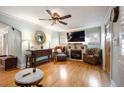Bright living room with hardwood floors, a decorative fireplace, and elegant furnishings at 3242 Utica St, Denver, CO 80212