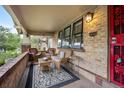 Cozy front porch featuring comfortable wicker seating and a stylish rug at 3242 Utica St, Denver, CO 80212
