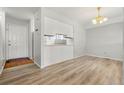 Bright dining area with light wood flooring and an open concept design at 1170 S Troy St, Aurora, CO 80012